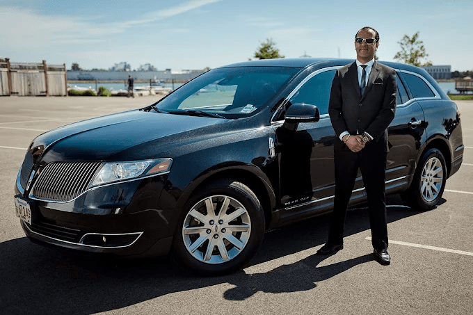a man next to a black car